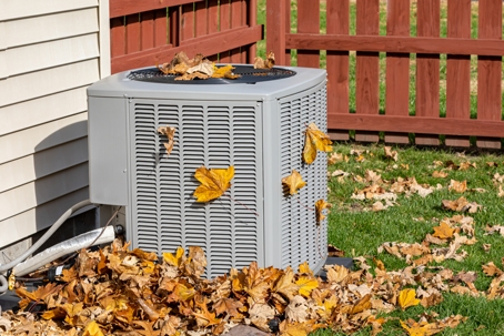 HVAC System Surrounded by Fall Leaves